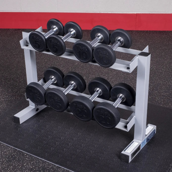 A rack holding a set of dumbbells in a gym, featuring weights of 5, 10, and 20 pounds, arranged neatly on a gray metal stand.
