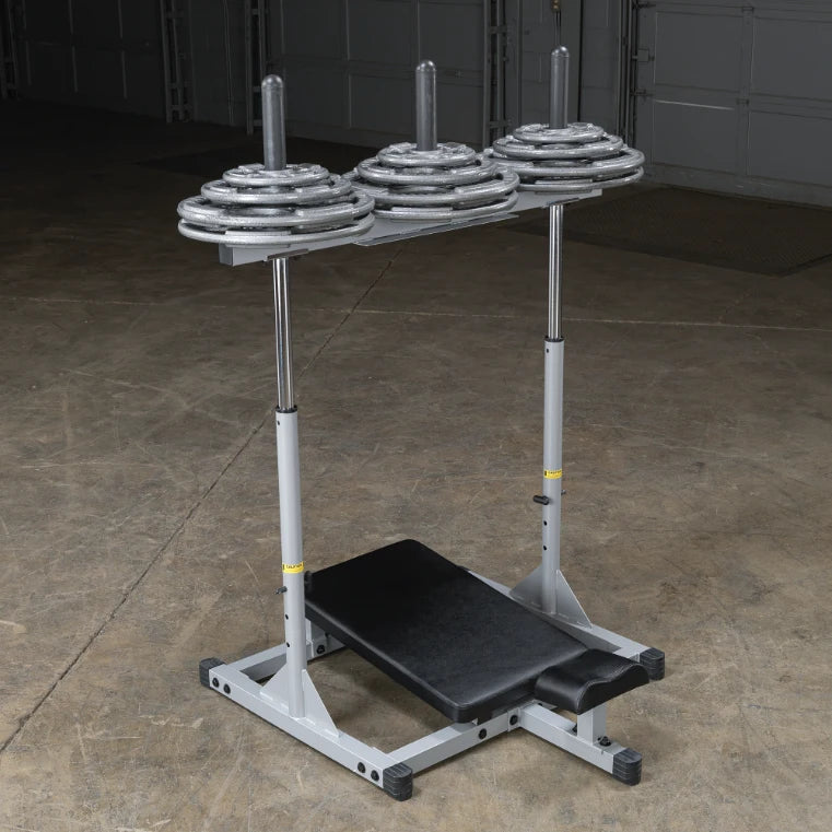 Weight bench with adjustable barbell holders and plates, set in a gym environment.