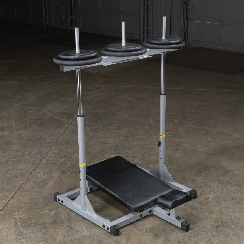 A weight bench with three weight plates on a bar, set against a concrete floor in a gym-like environment.