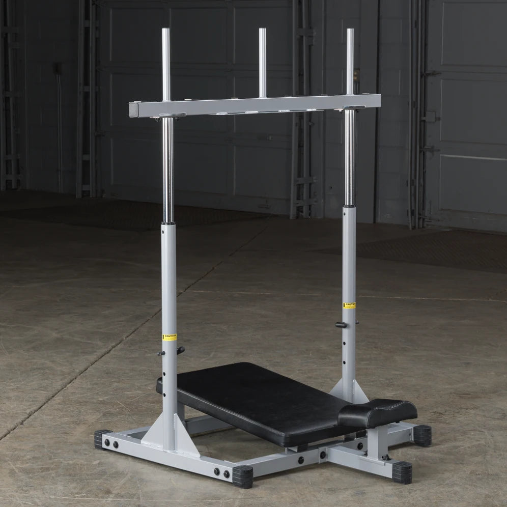 Weightlifting bench with adjustable support bars, set on a concrete floor in a gym environment.