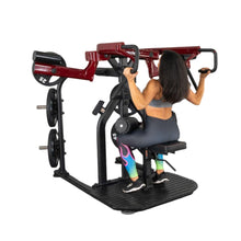 Woman using a red seated row machine with rainbow leggings in a gym.