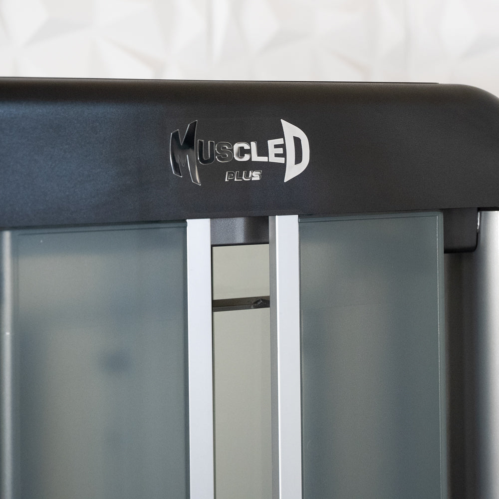 Muscle D Plus gym equipment with frosted glass panels and sleek black frame.
