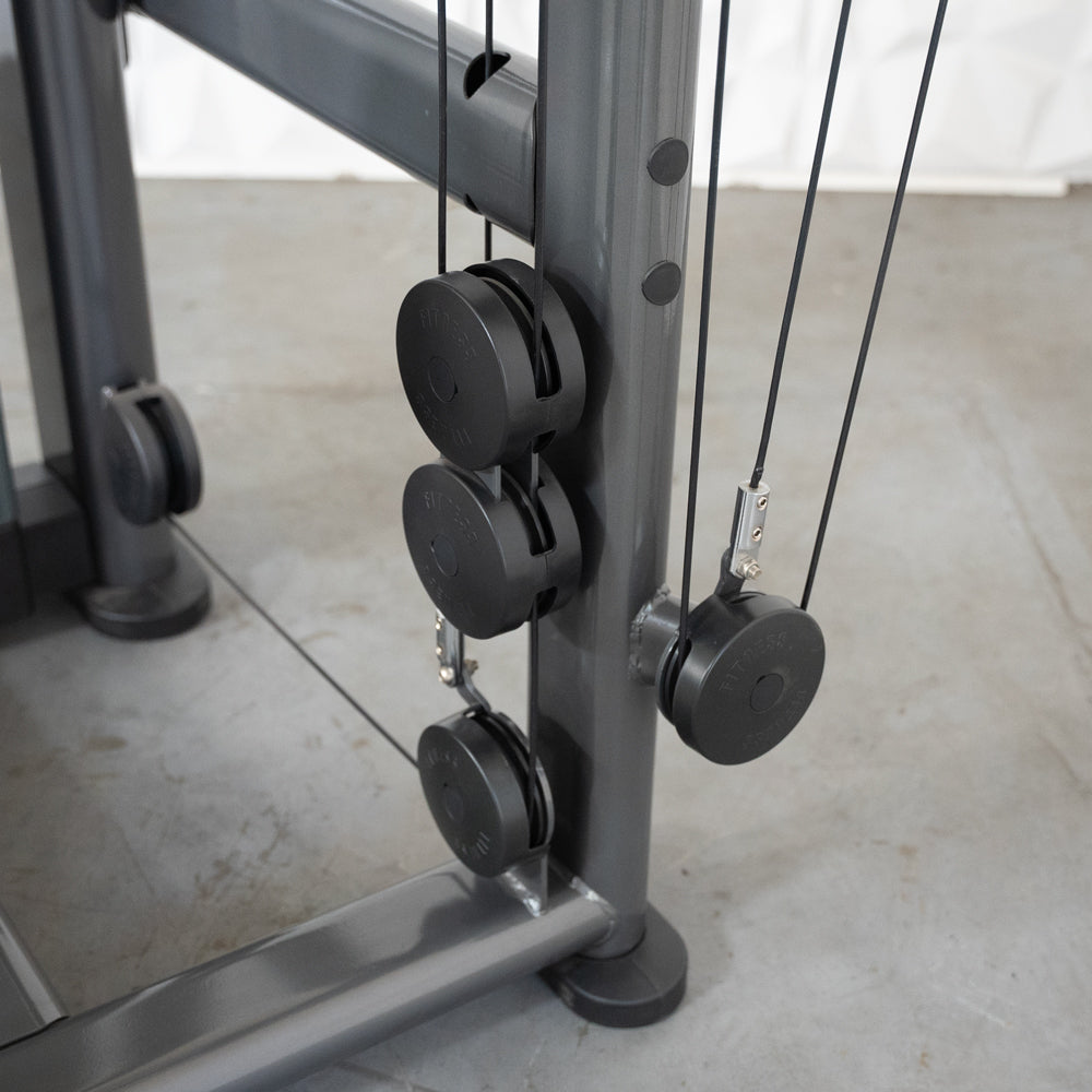 Fitness cable machine pulley system with black cables and metal frame.