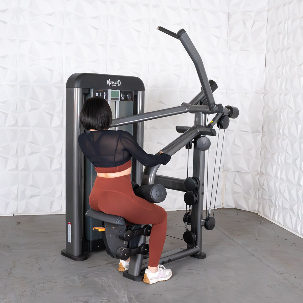 Person using Muscle D lat pulldown machine with black and gray design in a gym setting.