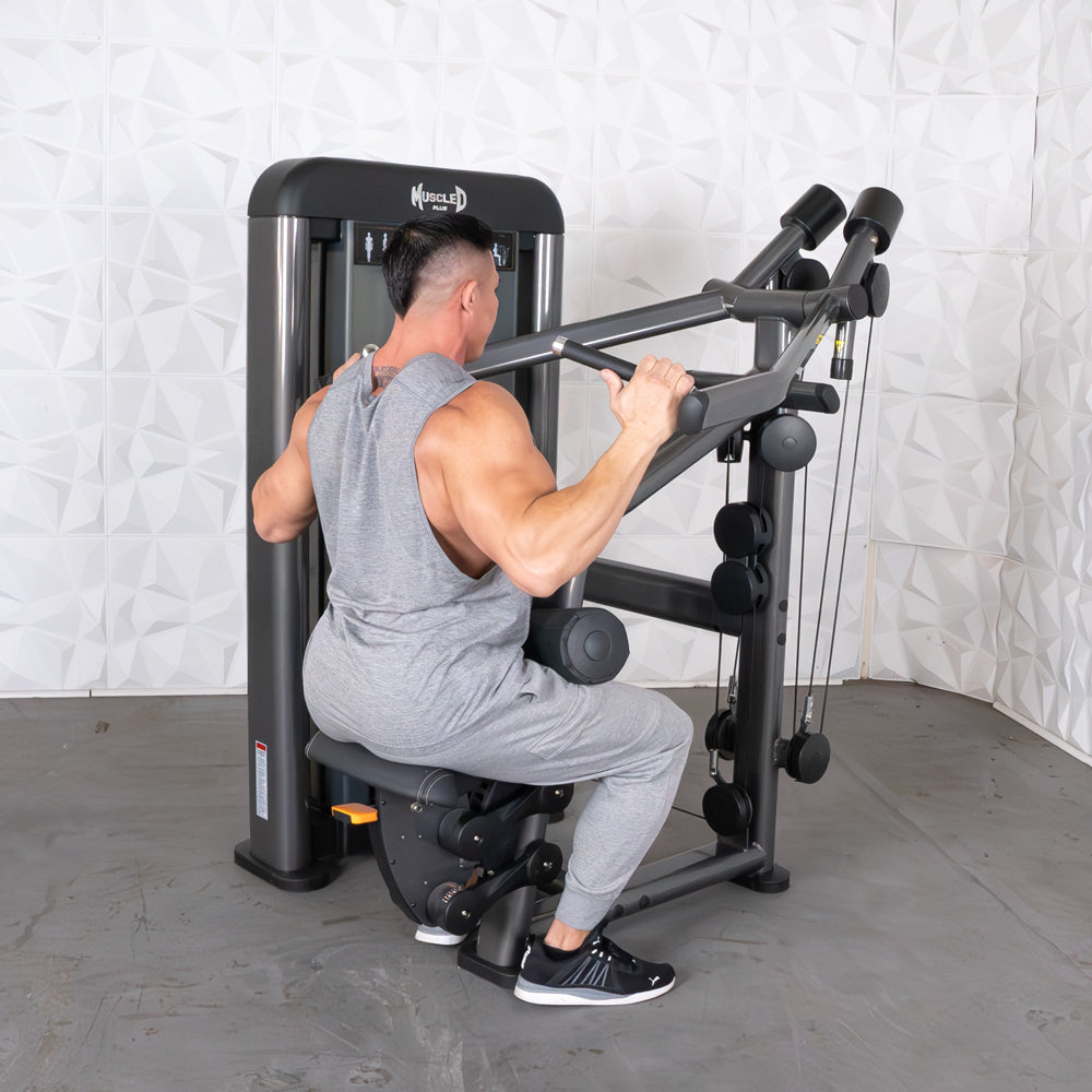 Man using Muscle D lat pulldown machine in gray tracksuit for strength training.