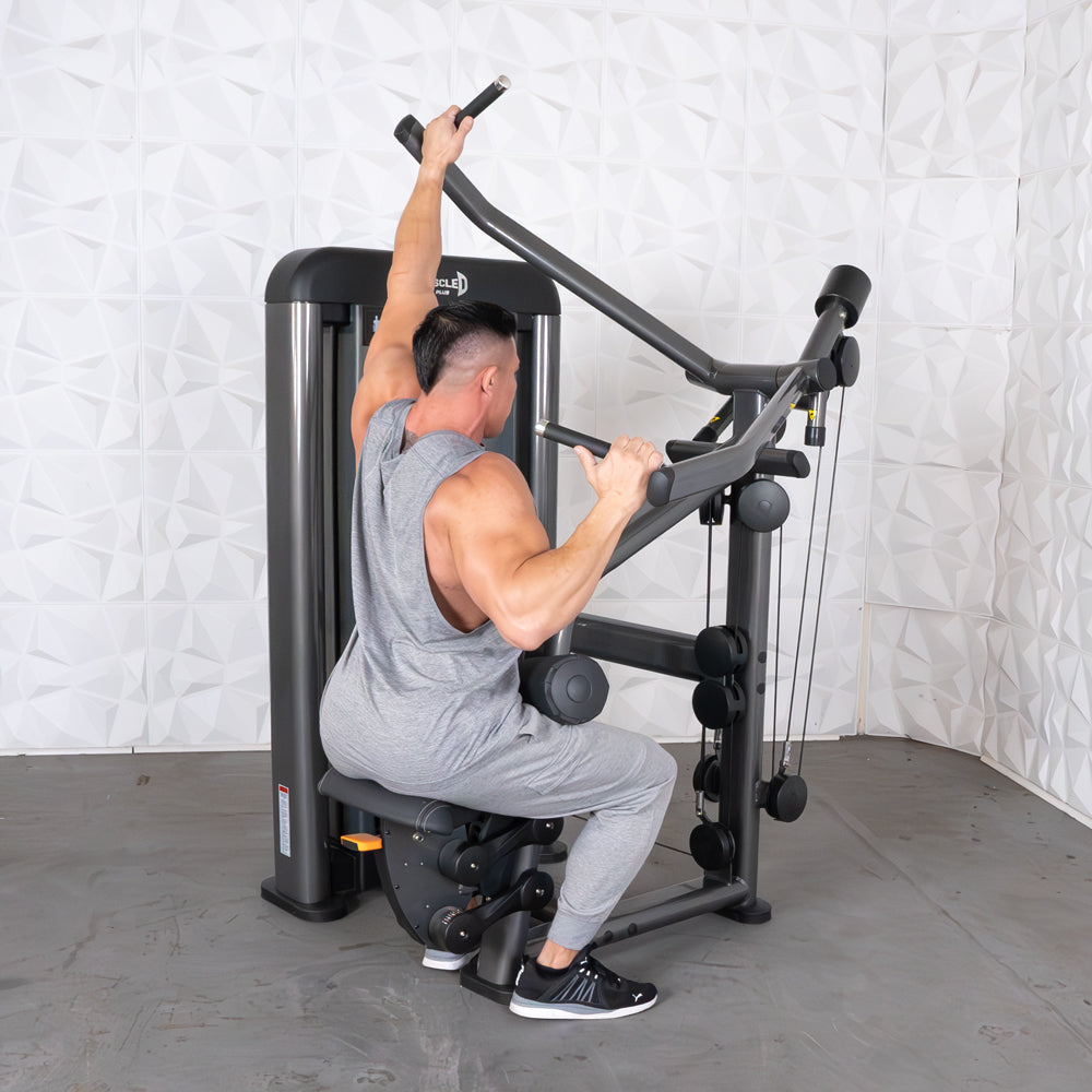 Man using Muscle D lat pulldown machine in gray workout attire.