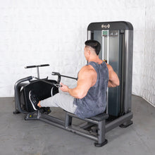 Man using Muscle D row machine with black handles in a gym.