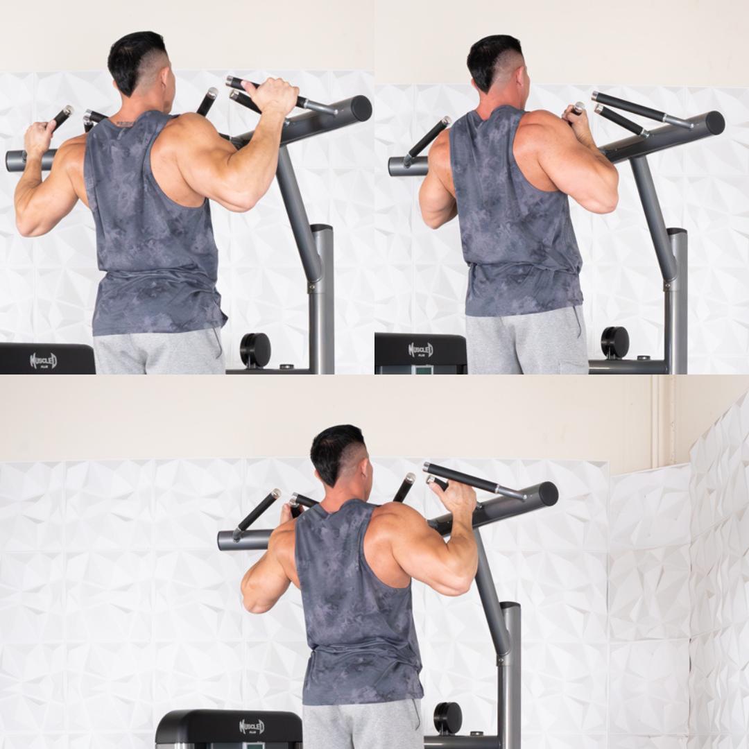 Man doing pull-ups on a Nautilus machine, wearing a gray tank top and shorts, showcasing back muscles.