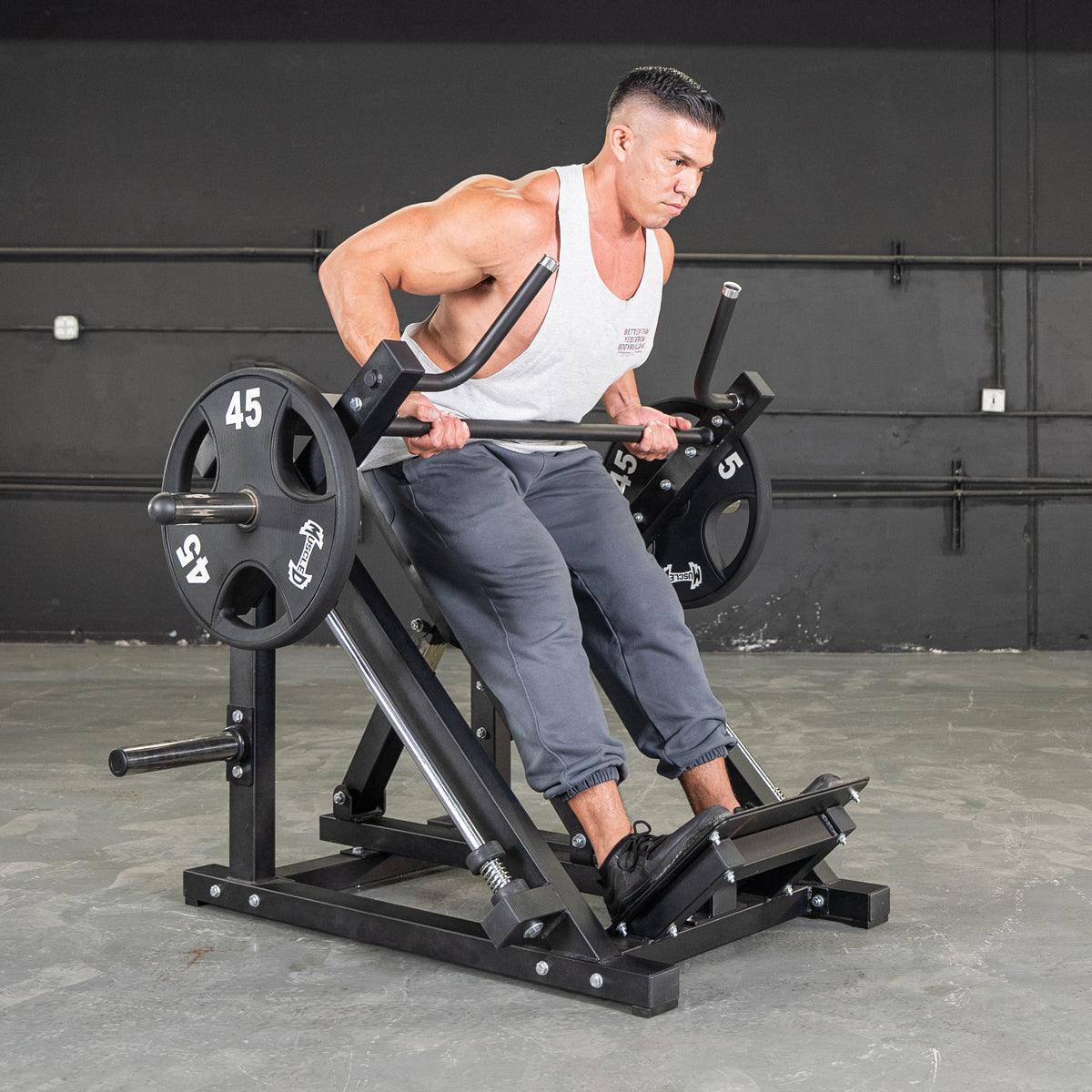 Man using seated row machine with 45 lb weights in gym.