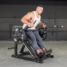 Man using a T-Bar row machine with 45 lb weights in a gym.