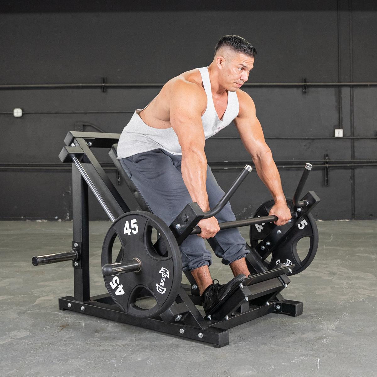 Man using T-Bar Row machine with 45-pound weights for back workout.