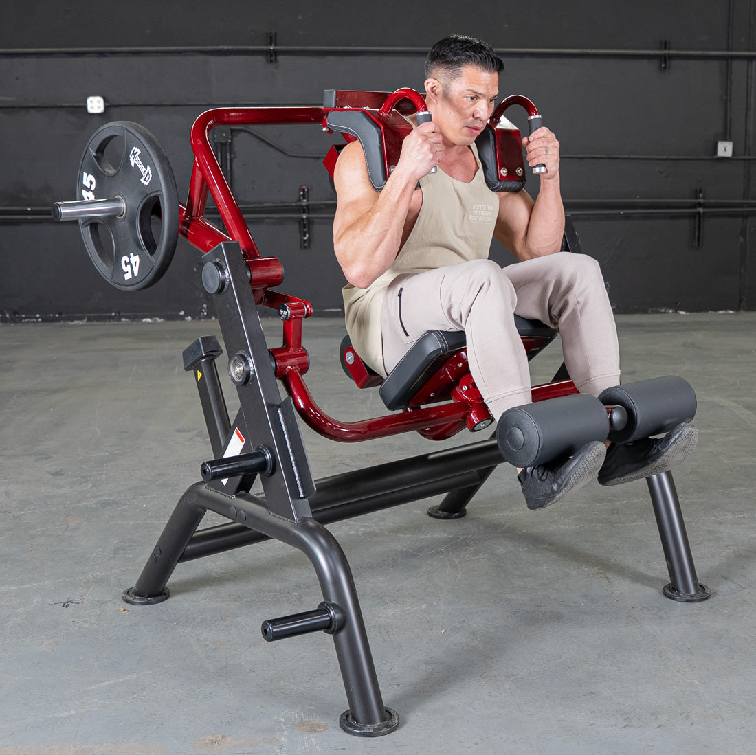 Man using red seated abdominal crunch machine for core workout.
