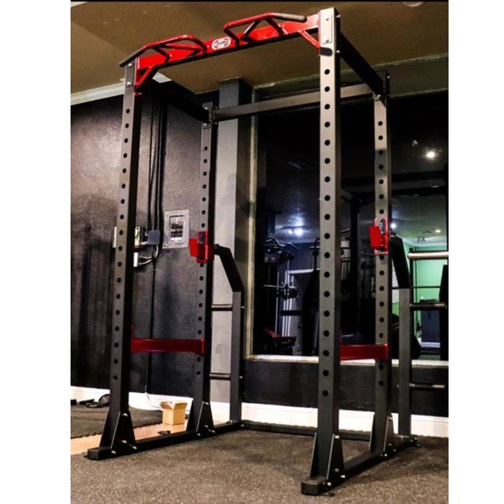 Black steel power rack with red safety hooks and pull-up bar.
