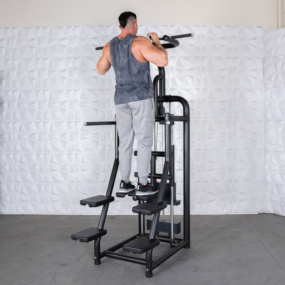Man using Fitness Reality X-Class pull-up machine in gray sweatpants.