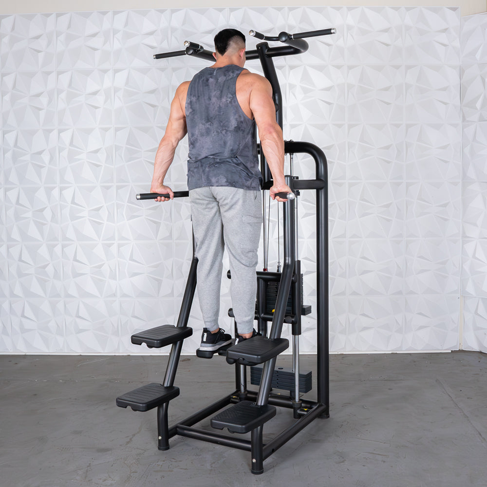Man using black dip station for tricep exercise in gym.