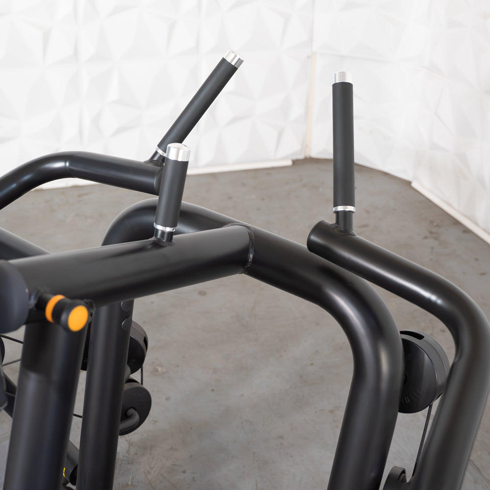 Black elliptical trainer with sleek handles in a modern gym setting.