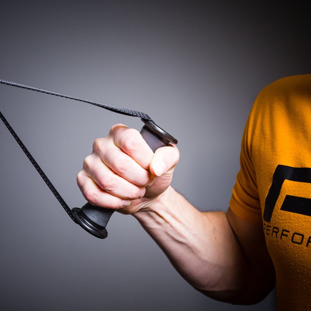 Close-up of a hand gripping a pulley system handle with a cord.