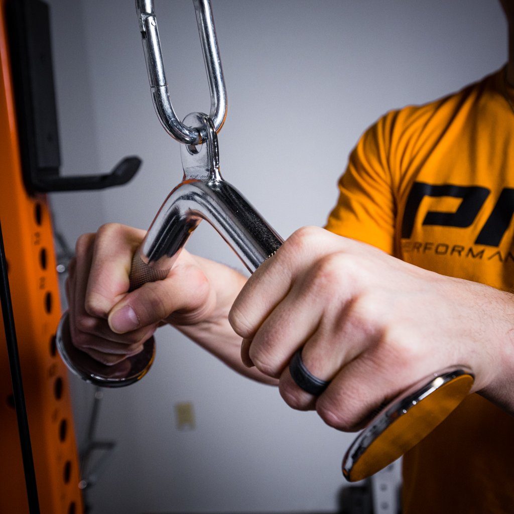 Close-up of hands gripping a chrome V-bar pulley handle.