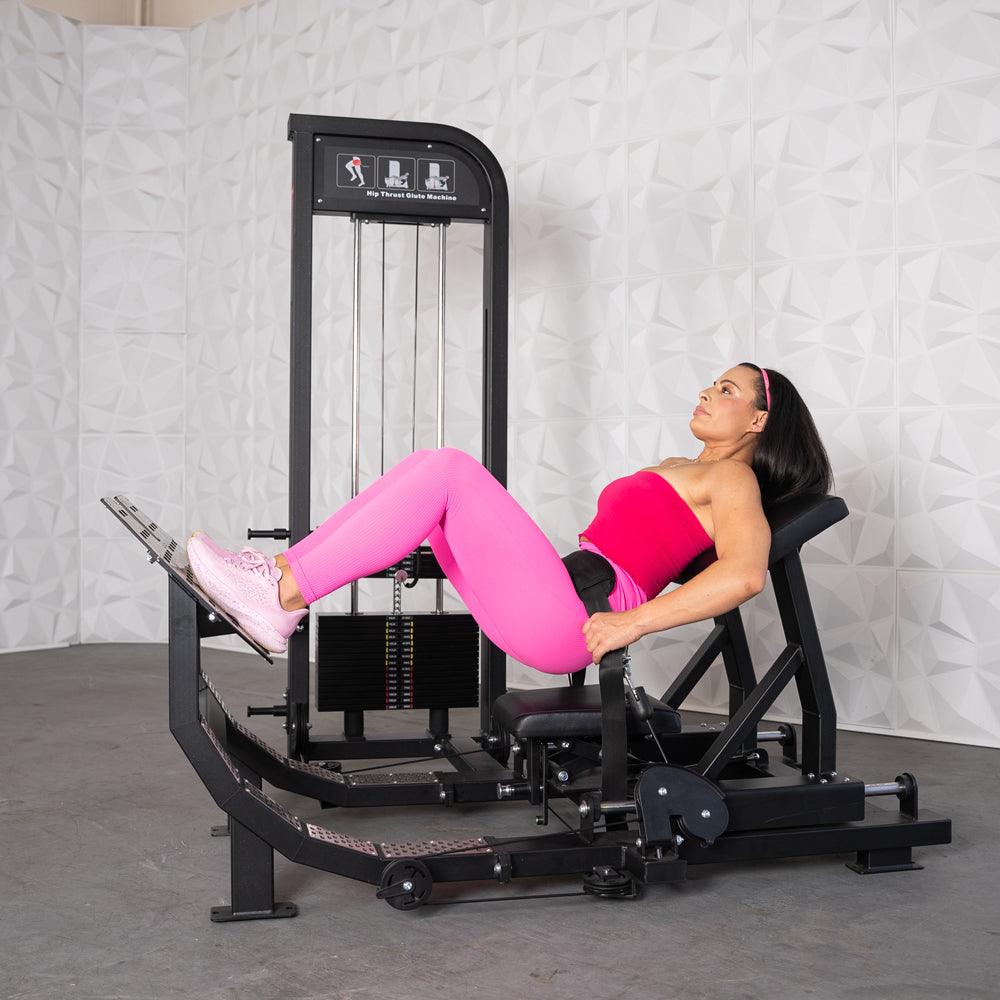 Woman at the top of a hip thrust on the Excel Selectorized Hip Thrust Glute Machine