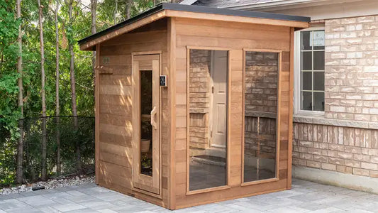 Person relaxing in a hot wooden sauna illustrating how long to stay inside