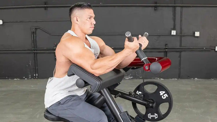 Man performing a bicep curl on the Muscle D Fitness Power Leverage V2 Bicep / Preacher Curl Machine