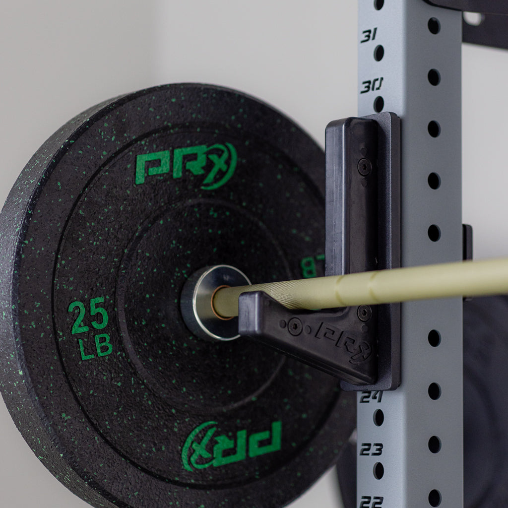 PRx 25 lb weight plate on a barbell in a power rack.