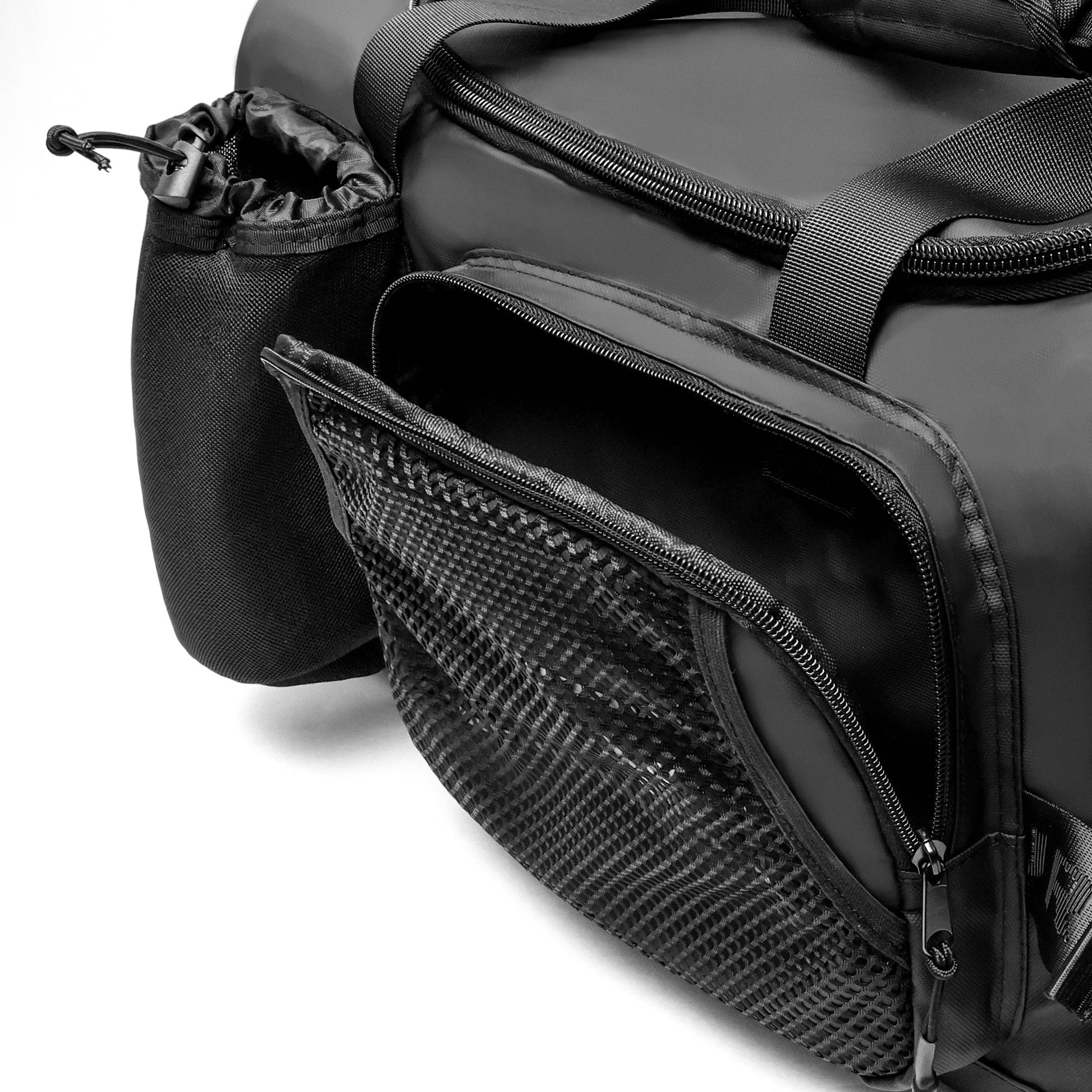 Close-up of a black duffel bag with a zippered pocket and mesh side panel.