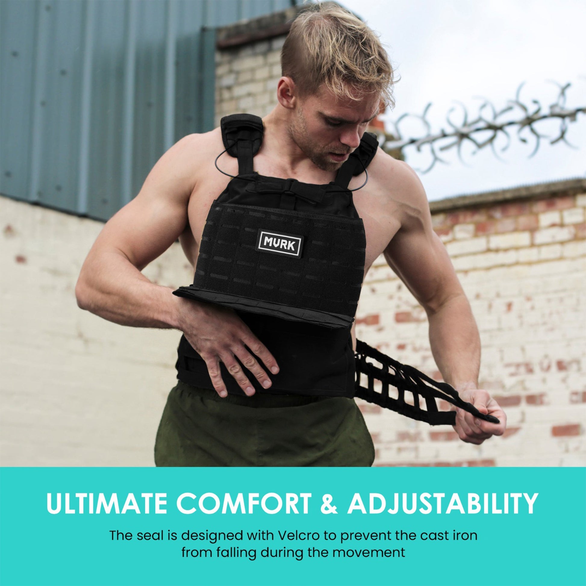 Muscular man in black tactical vest labeled MVRK outdoors.