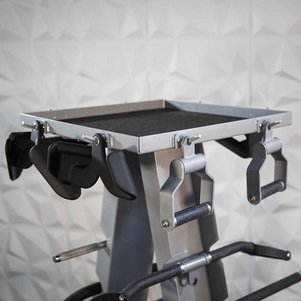Gym accessory rack with handles on a weight machine.