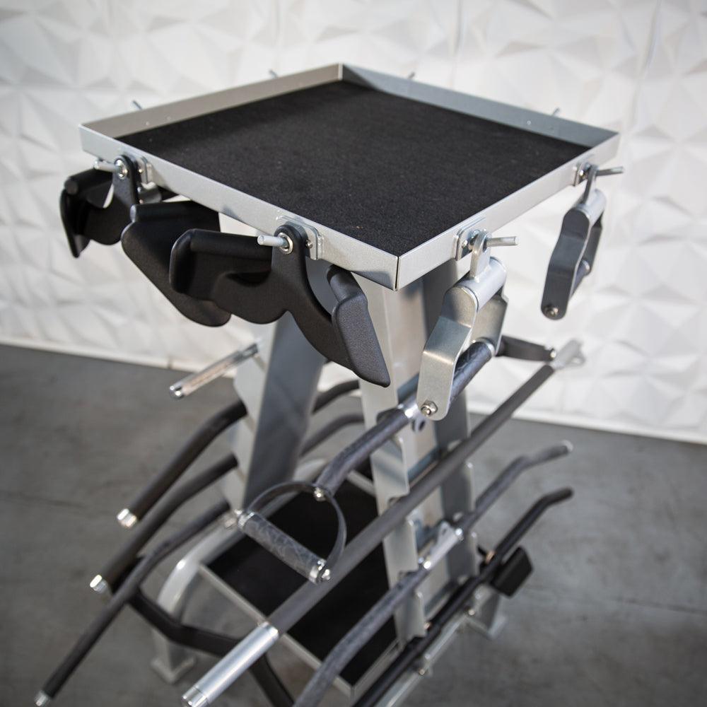 Metal accessory rack with multiple clamps and a black top tray.