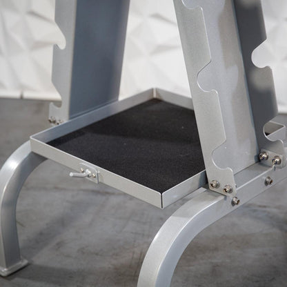 Metallic accessory rack with a black tray shelf and curved legs.