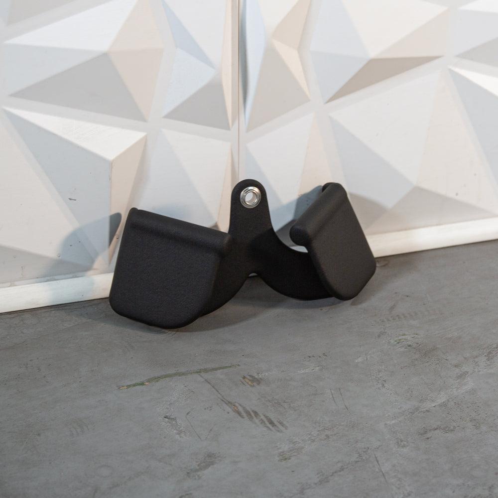 Set of black door handle accessories with a mounting tab.