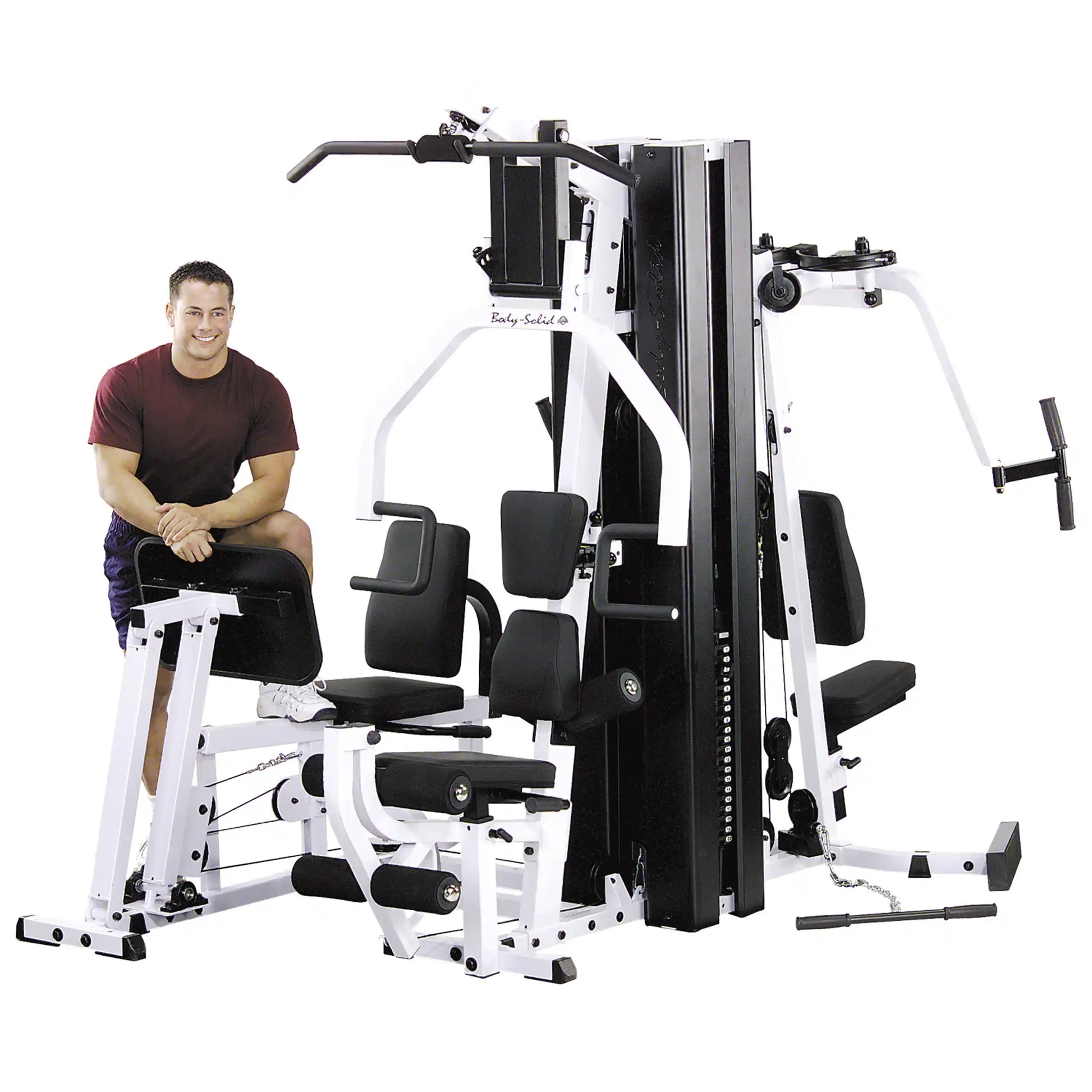 Body-Solid home gym with a man in red shirt, featuring a multi-station design for versatile workouts.