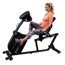 Woman exercising on Endurance B4R recumbent bike in snakeskin leggings.