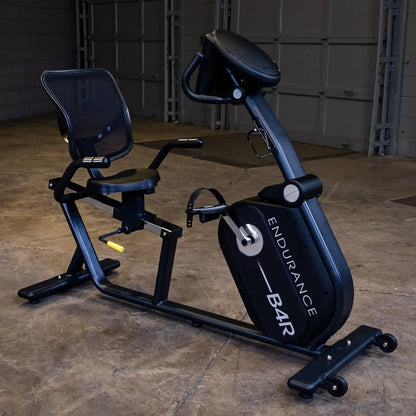 Endurance B4R recumbent exercise bike with mesh seat in a garage setting.