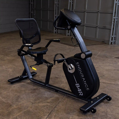Endurance B4R recumbent exercise bike with mesh seat in a garage setting.