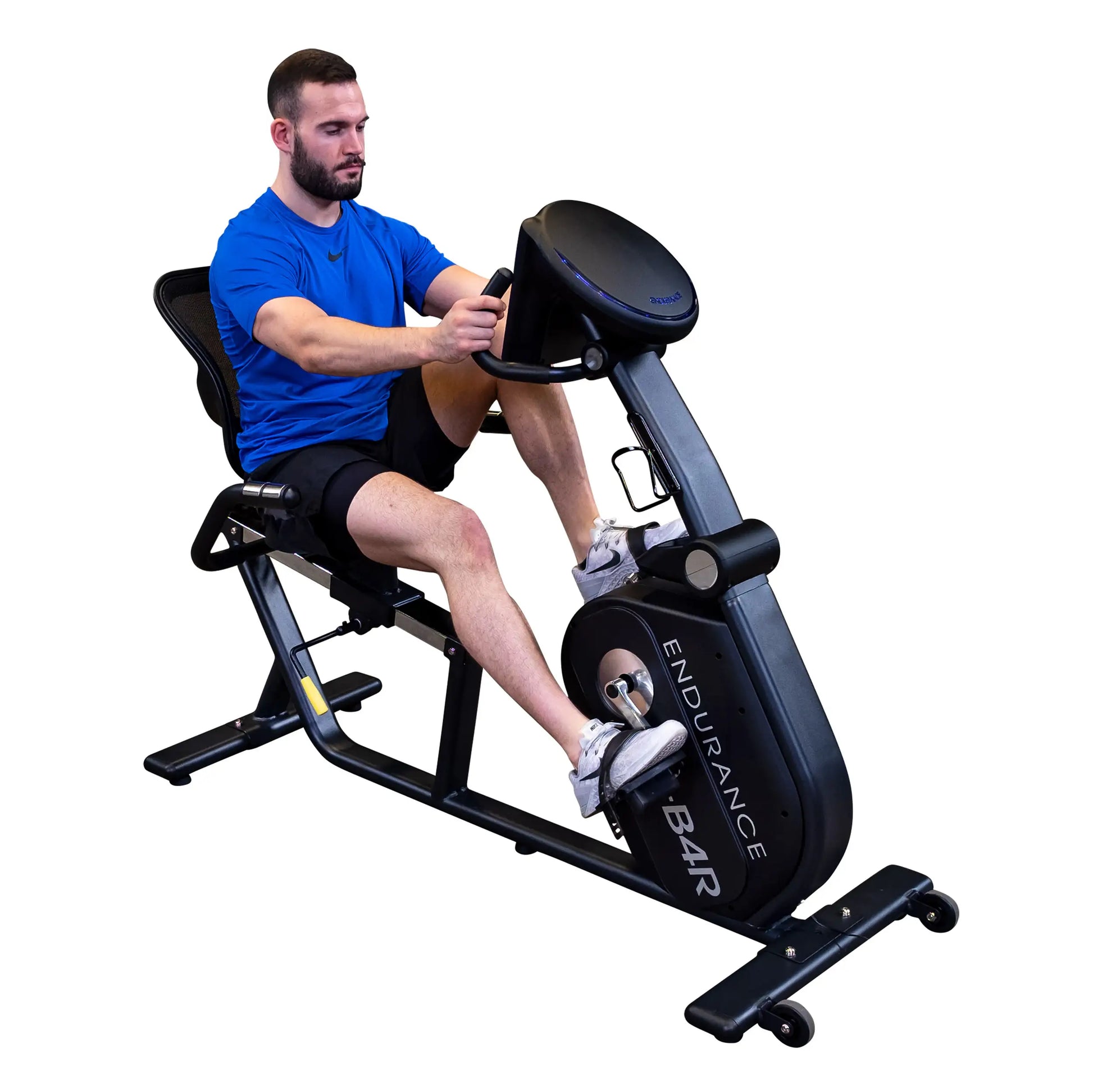 Man exercising on Body-Solid Endurance B4R recumbent bike in blue shirt.