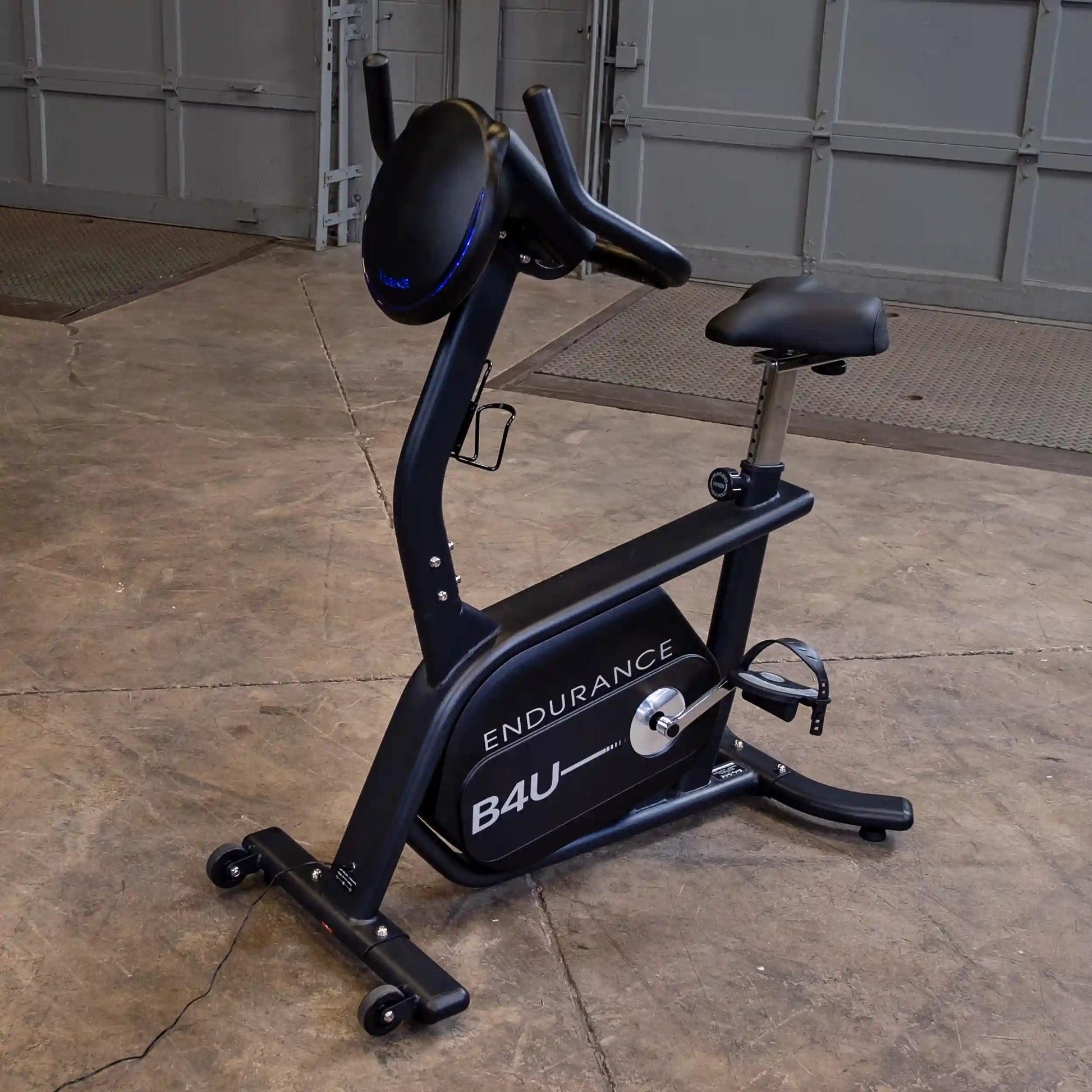 Endurance B4U exercise bike with adjustable seat in a garage setting.