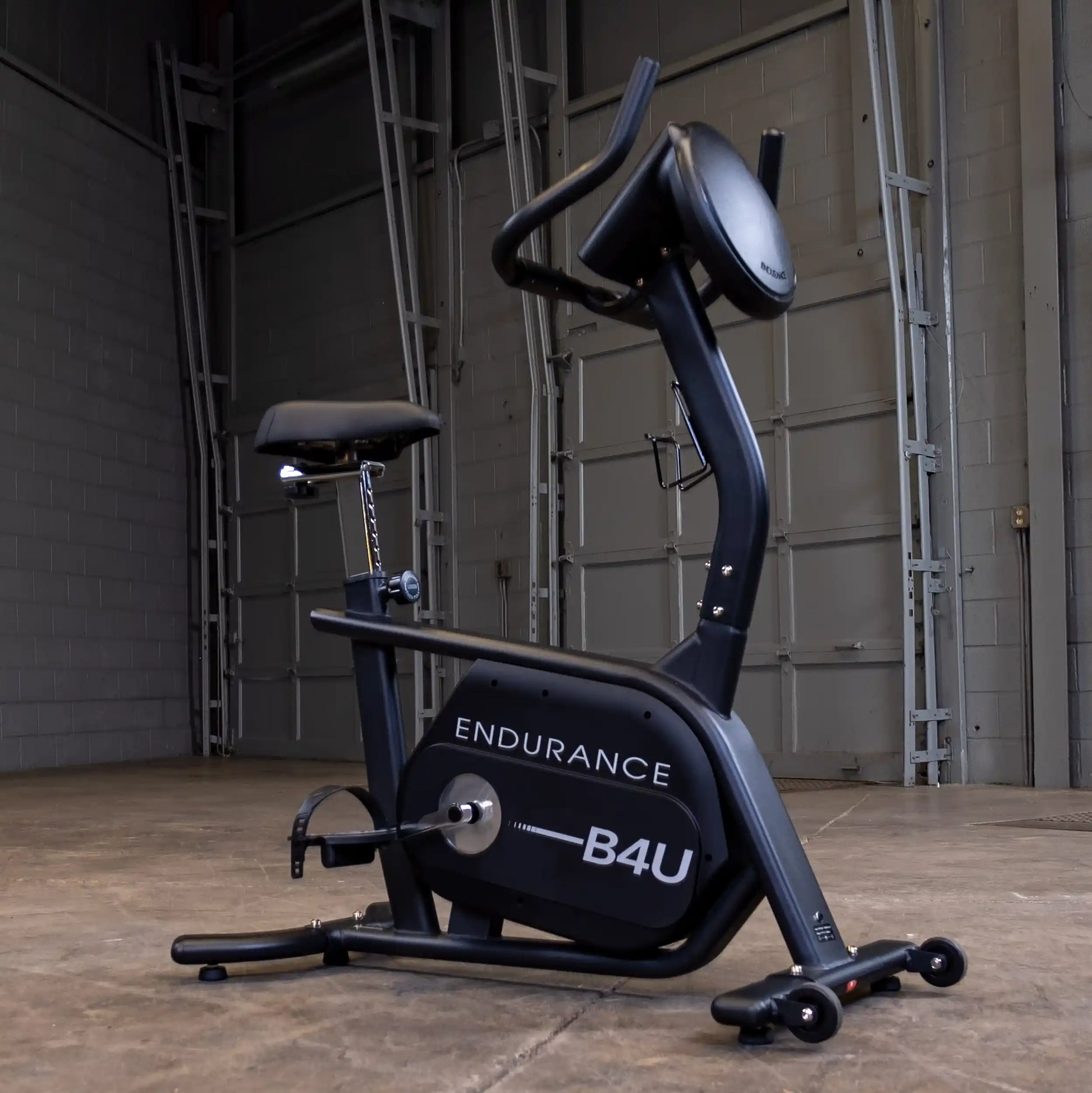 Endurance B4U stationary bike in a garage setting, featuring a sleek black design.