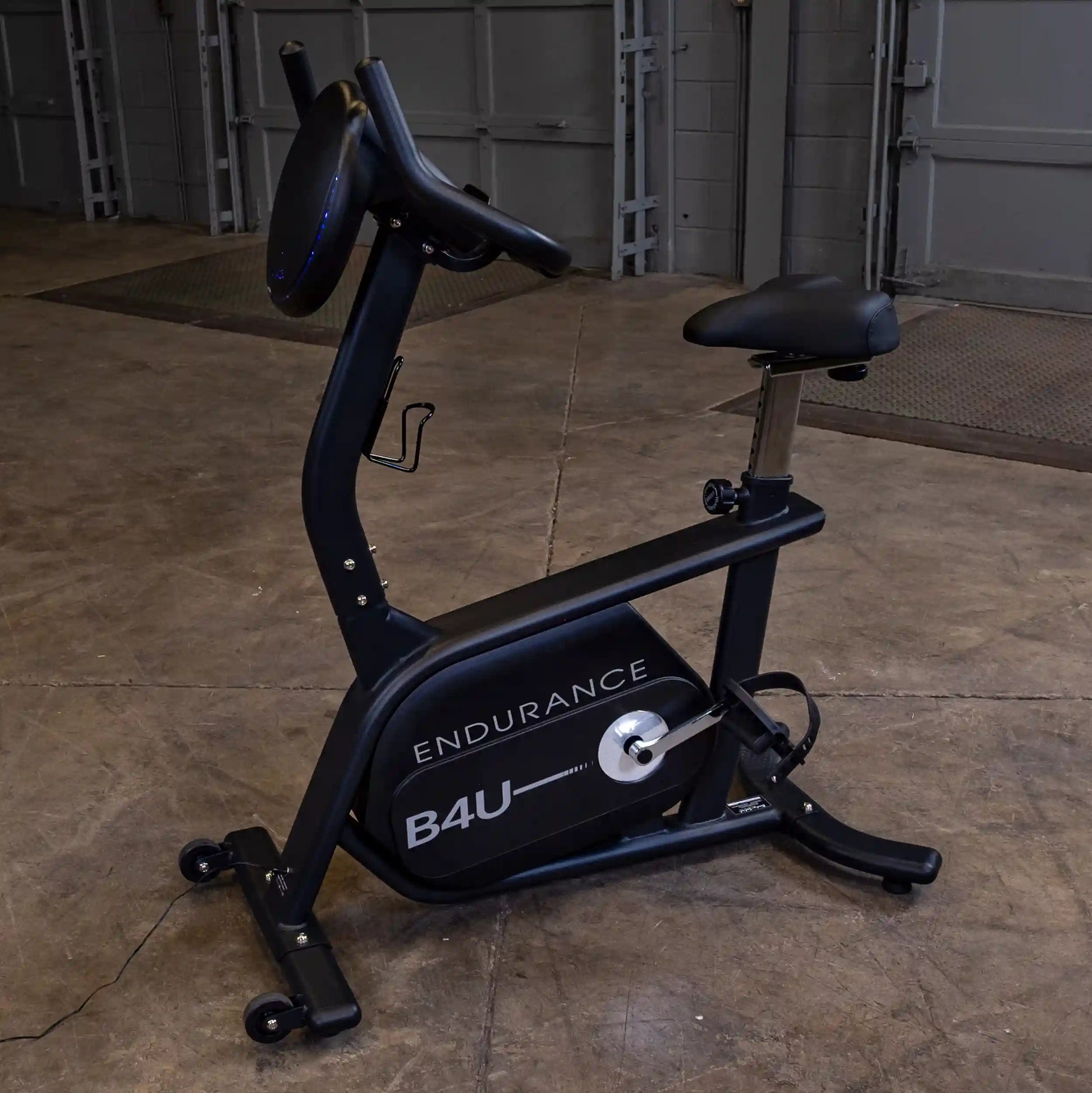 Endurance B4U exercise bike in black with ergonomic seat in a garage setting.