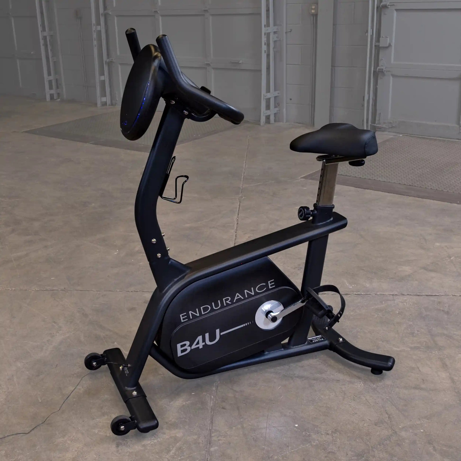 Endurance B4U exercise bike with adjustable seat in a gray gym setting.