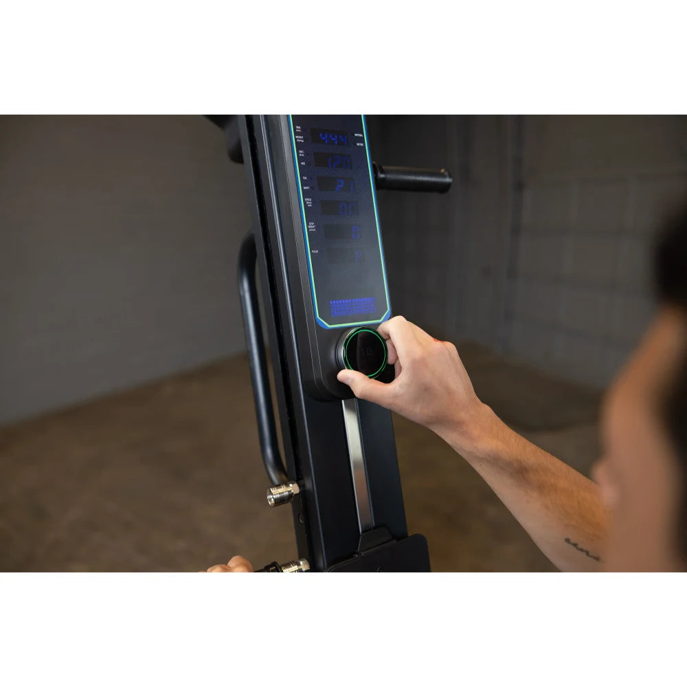 Adjusting settings on a black NordicTrack exercise machine with digital display.