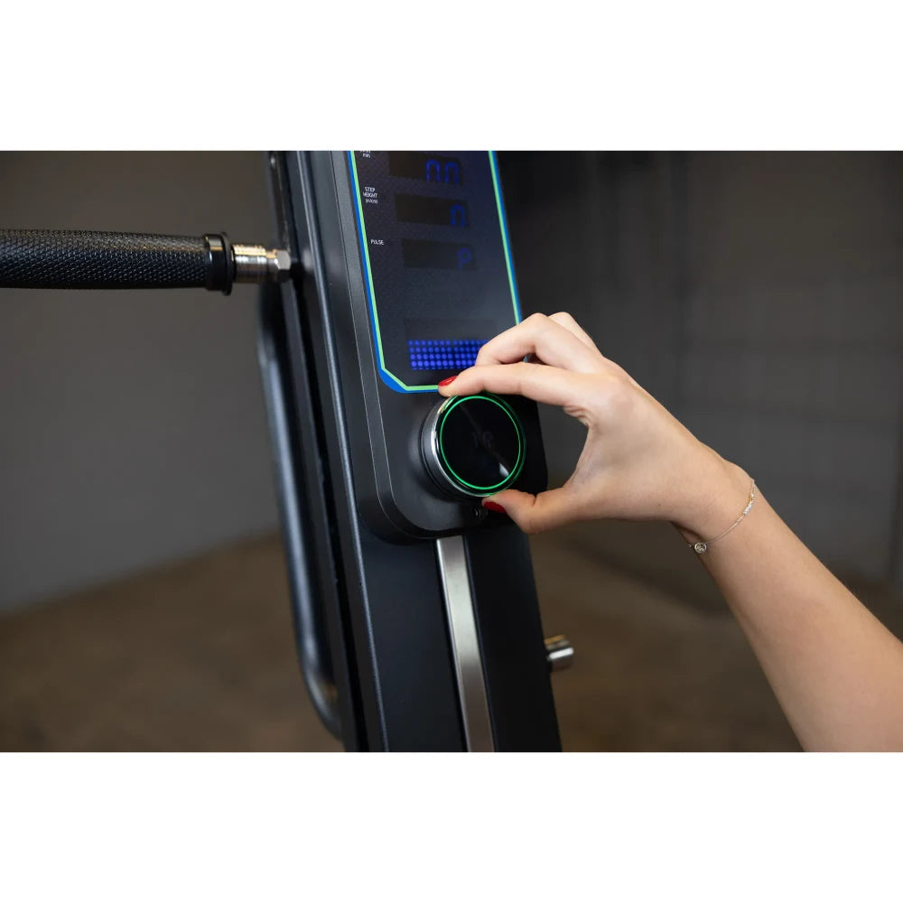 Hand adjusting NordicTrack rowing machine resistance knob.