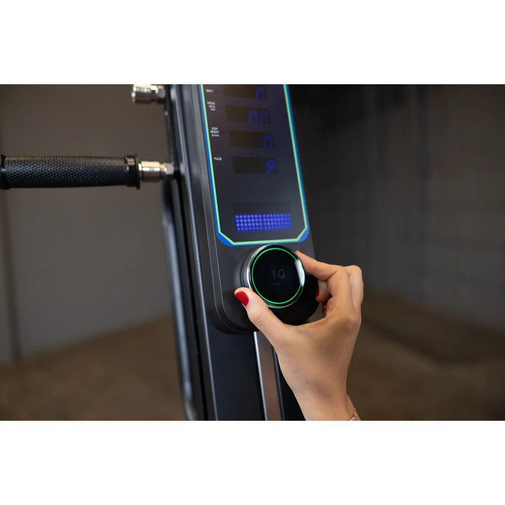 Adjusting resistance on NordicTrack rowing machine's digital display with sleek black knob.