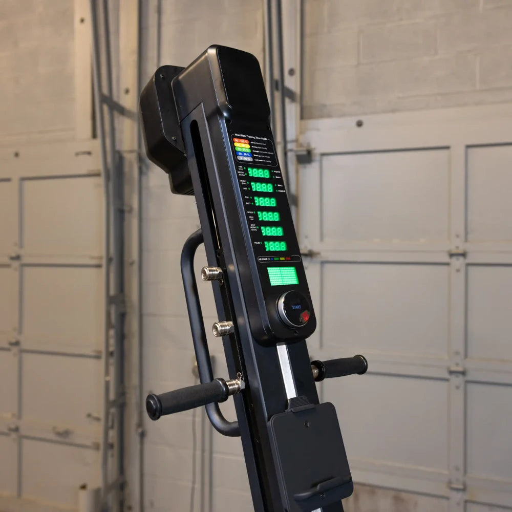 Vertical climber machine with digital display in a gym setting.