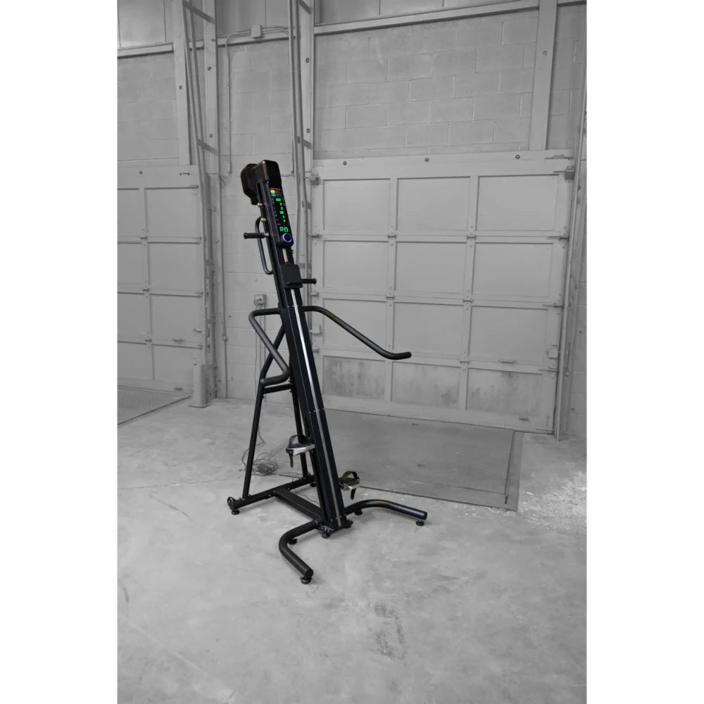 Vertical climber machine with digital display in industrial setting.