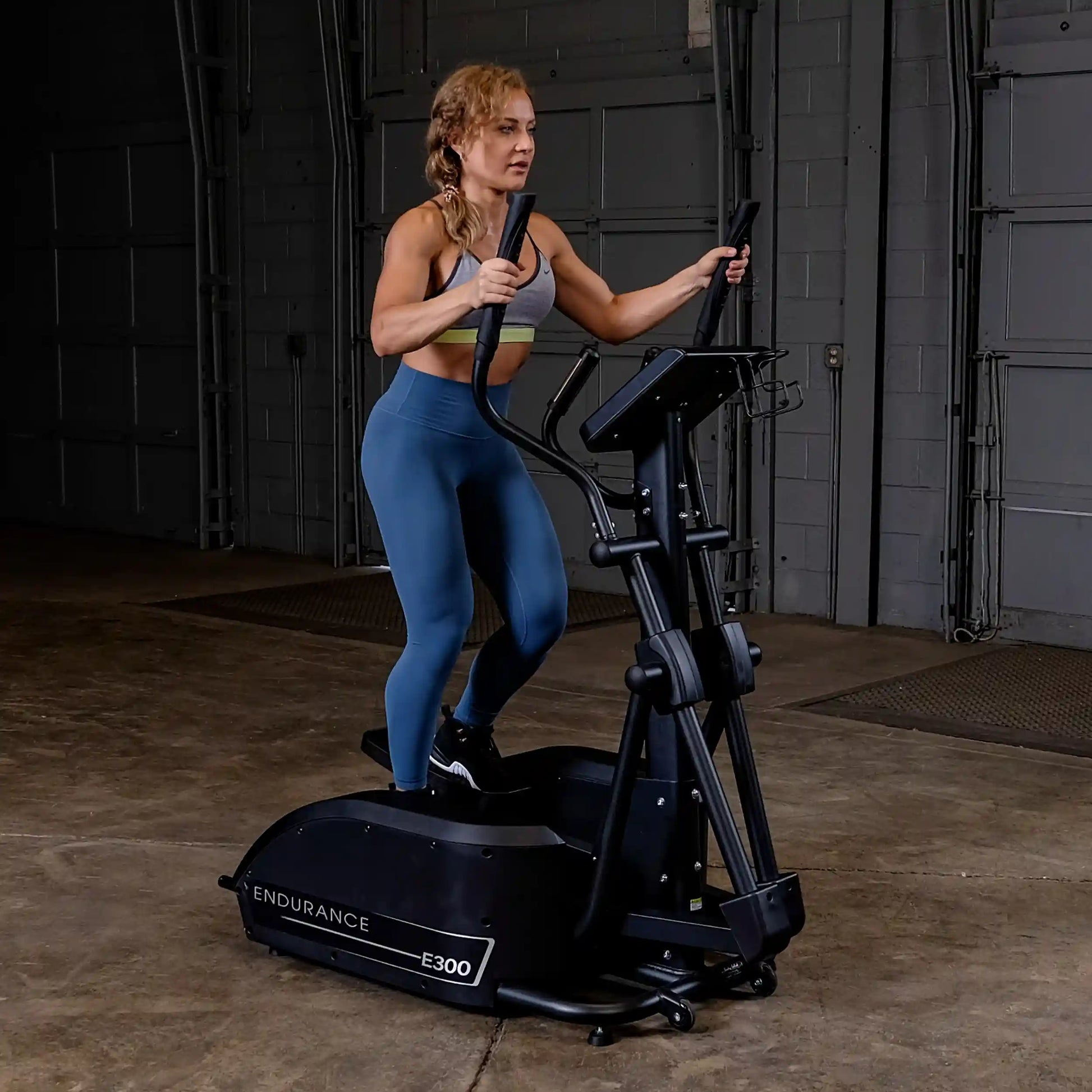 Person using Endurance E300 elliptical trainer in a gym setting.