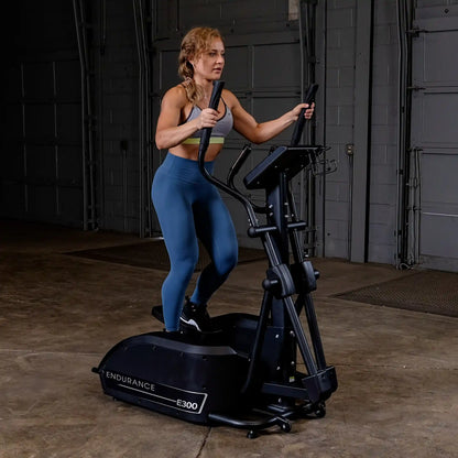 Person using Endurance E300 elliptical trainer in a gym setting.