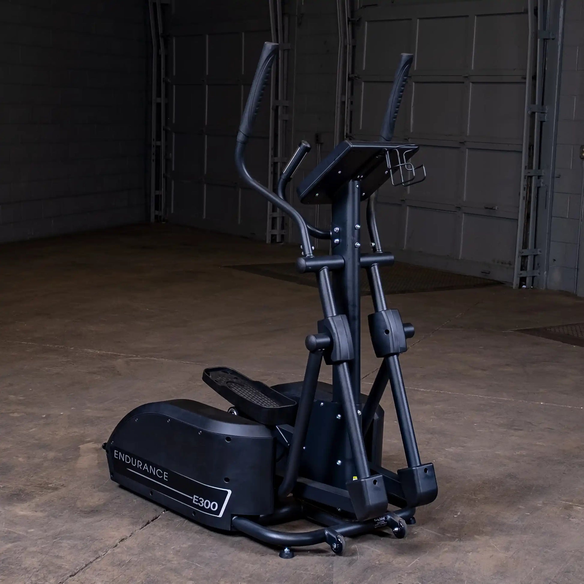 Endurance E300 elliptical trainer in black, featuring dual-action handlebars in a spacious gym setting.