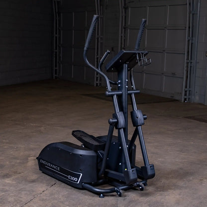 Endurance E300 elliptical trainer in black, featuring dual-action handlebars in a spacious gym setting.